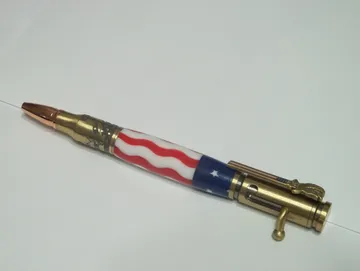 Salute America bolt-action pen finished in antique brass with a flag clip