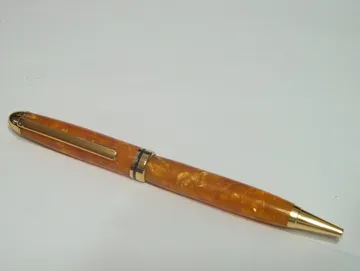 Designer twist pen in orange crush resin with 24kt gold trim