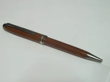 Designer twist pen turned from osage orange with gun metal trim