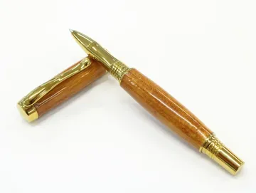 Diamond knurl rollerball turned from hardwood with gold titanium trim
