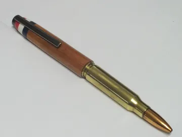 Military rifle cartridge pen in afzelia with a gun metal clip and Corian flag inlay