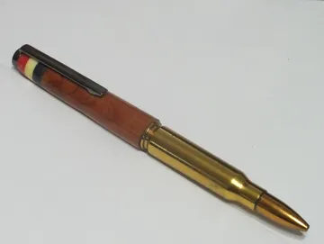 Military rifle cartridge pen in cedar with a gun metal clip and Corian flag inlay