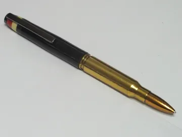 Military rifle cartridge pen in gaboon ebony with a gun metal clip and Corian flag inlay