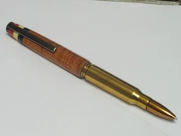 Military rifle cartridge pen in padauk with a gun metal clip and Corian flag inlay