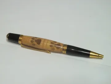 Sierra pen finished in gold titanium nitride with a paw print inlay barrel