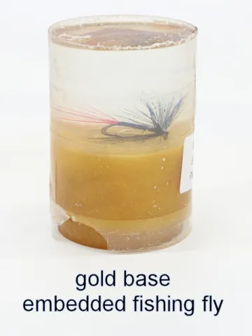 Bottle stopper blank with an embedded fishing fly over a gold base