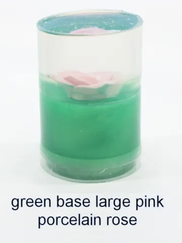 Bottle stopper blank with a large pink porcelain rose over a green base