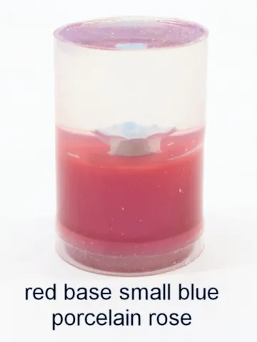 Bottle stopper blank with a smaller blue porcelain rose over a red base