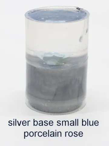 Bottle stopper blank with a smaller blue porcelain rose over a silver base