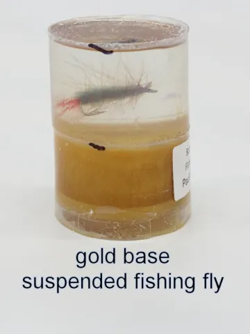 Bottle stopper blank with a suspended fishing fly over a gold base
