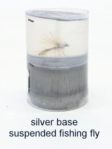 Bottle stopper blank with a suspended fishing fly over a silver base