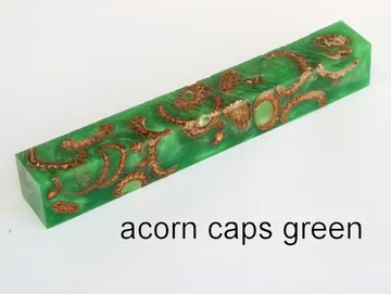 Pen blank of acorn caps suspended in green resin