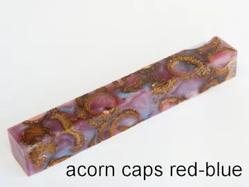 Pen blank of acorn caps suspended in red and blue resin