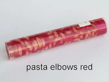 Pen blank of elbow pasta suspended in red resin