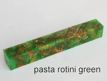 Pen blank of tri-colored rotini pasta suspended in green resin