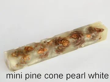 Pen blank of mini pine cones suspended in pearl white resin