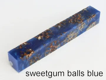 Pen blank of sweet gum balls suspended in blue resin