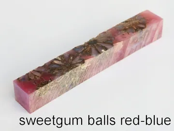 Pen blank of sweet gum balls suspended in red and blue resin