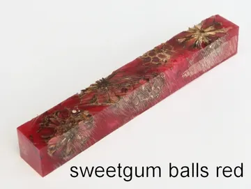 Pen blank of sweet gum balls suspended in red resin