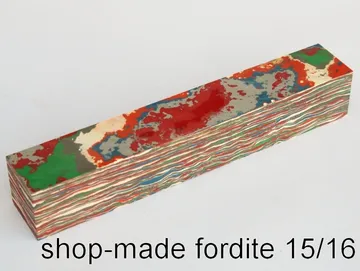 Shop-made fordite pen blank, 15/16 inch square, with swirled red, green and grey paint layers
